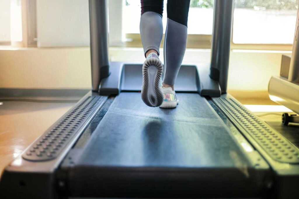 A modern foldable treadmill in a sleek home gym