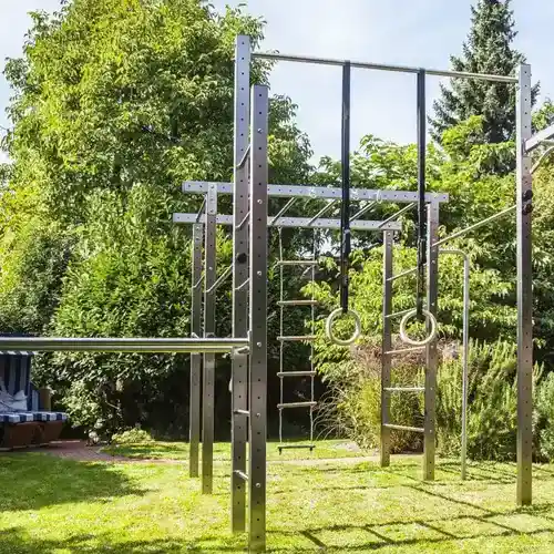 Outdoor Gym Ideas for Backyards: 15 Stylish & Practical Setups 9 Outdoor backyard functional fitness area with kettlebells and training equipment