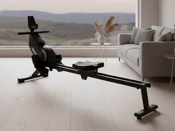 Compact magnetic rower in a minimalist apartment home gym for quiet full-body cardio workouts.